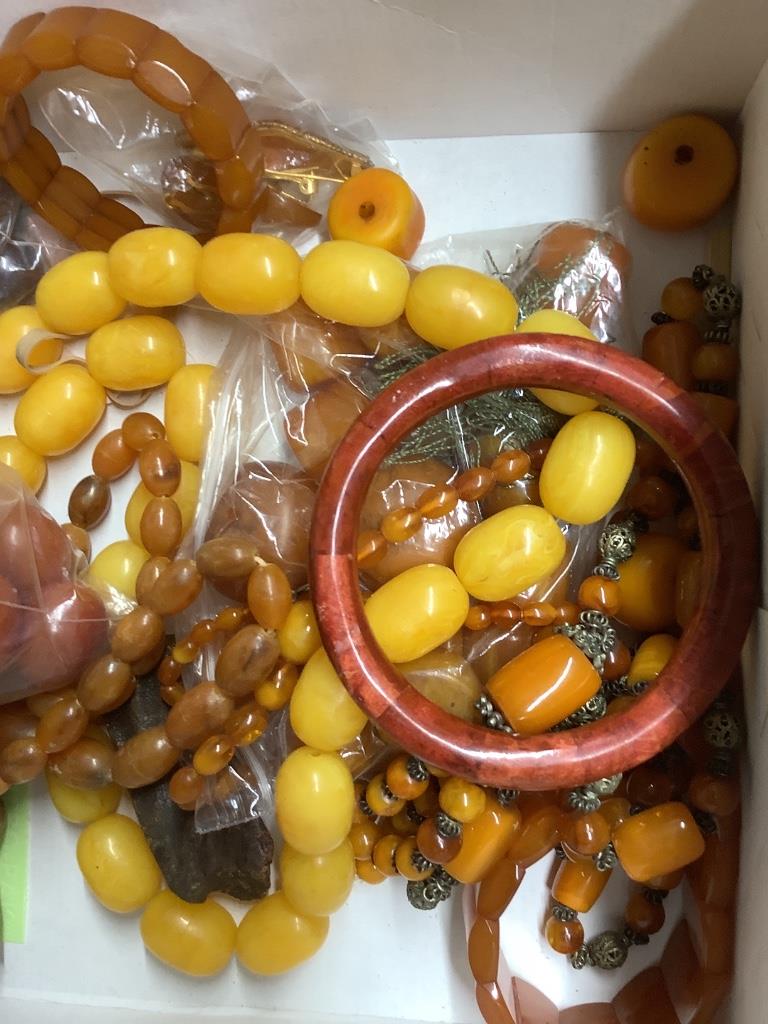 A quantity of assorted amber and faux amber necklaces.